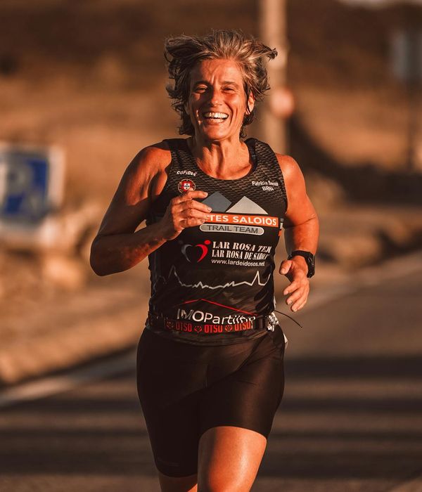Young woman performing active cardio exercises in a modern sunlit studio.
